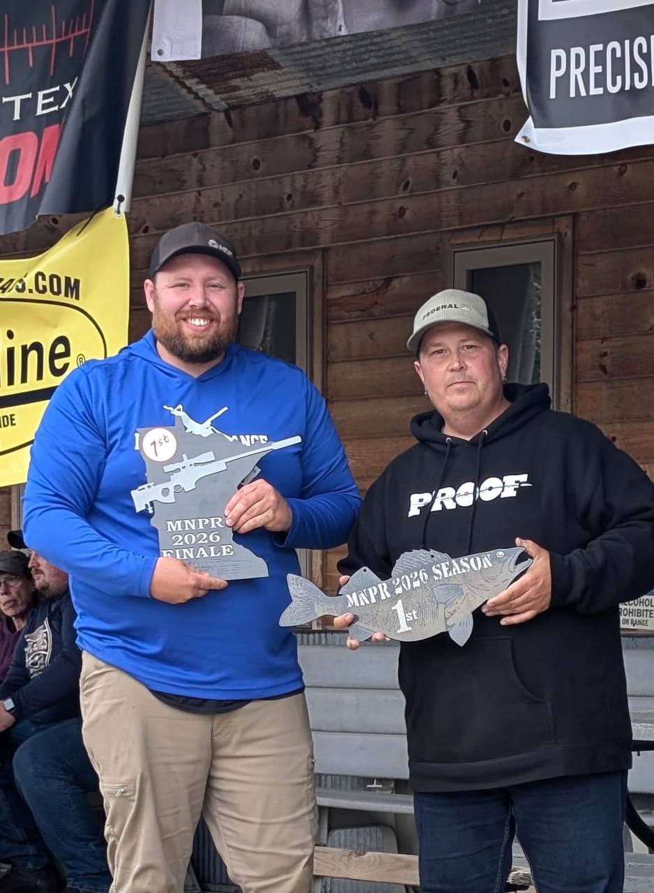 Robert Peterson in the blue shirt on the left, holding a finale award
